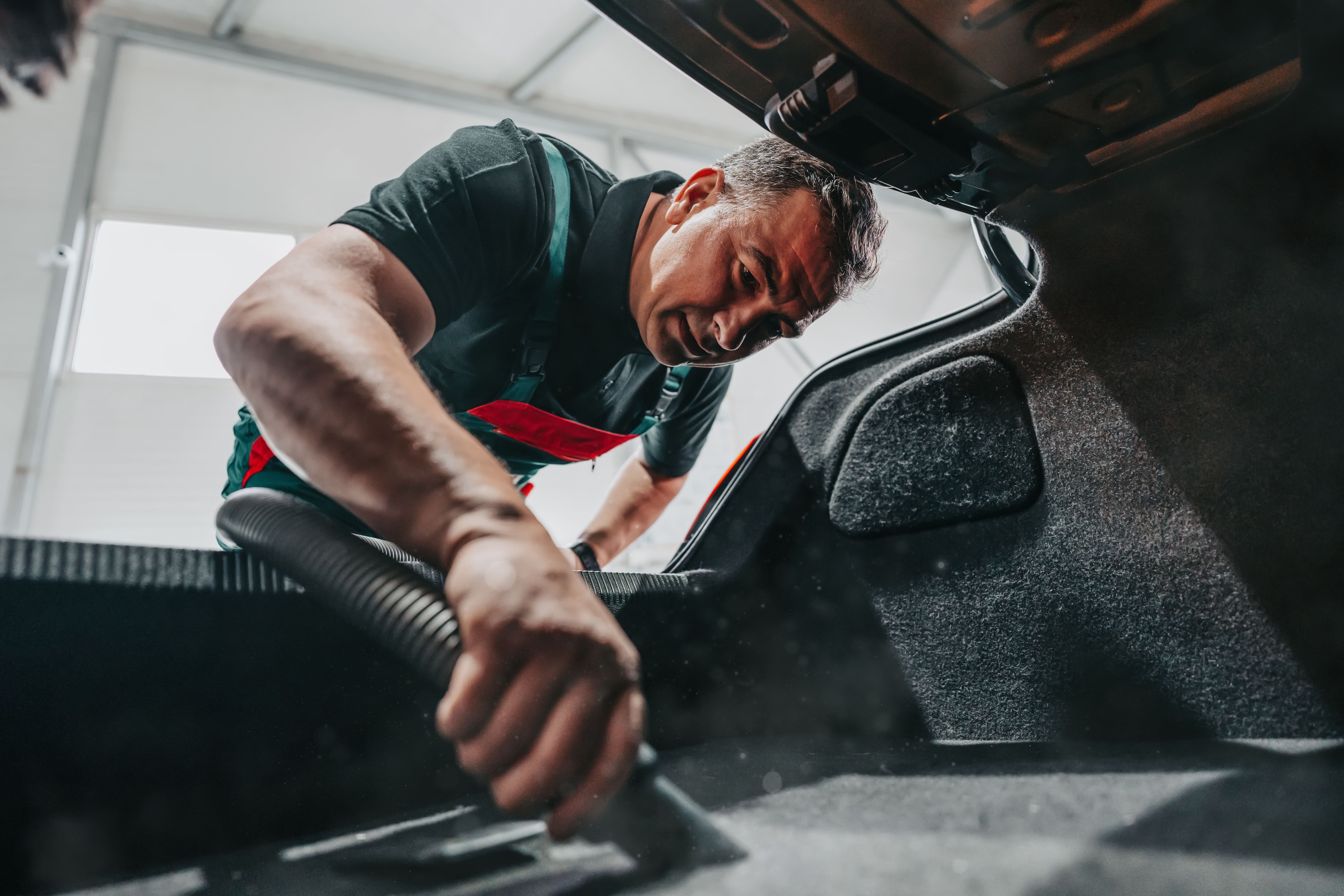 Man vacuuming car