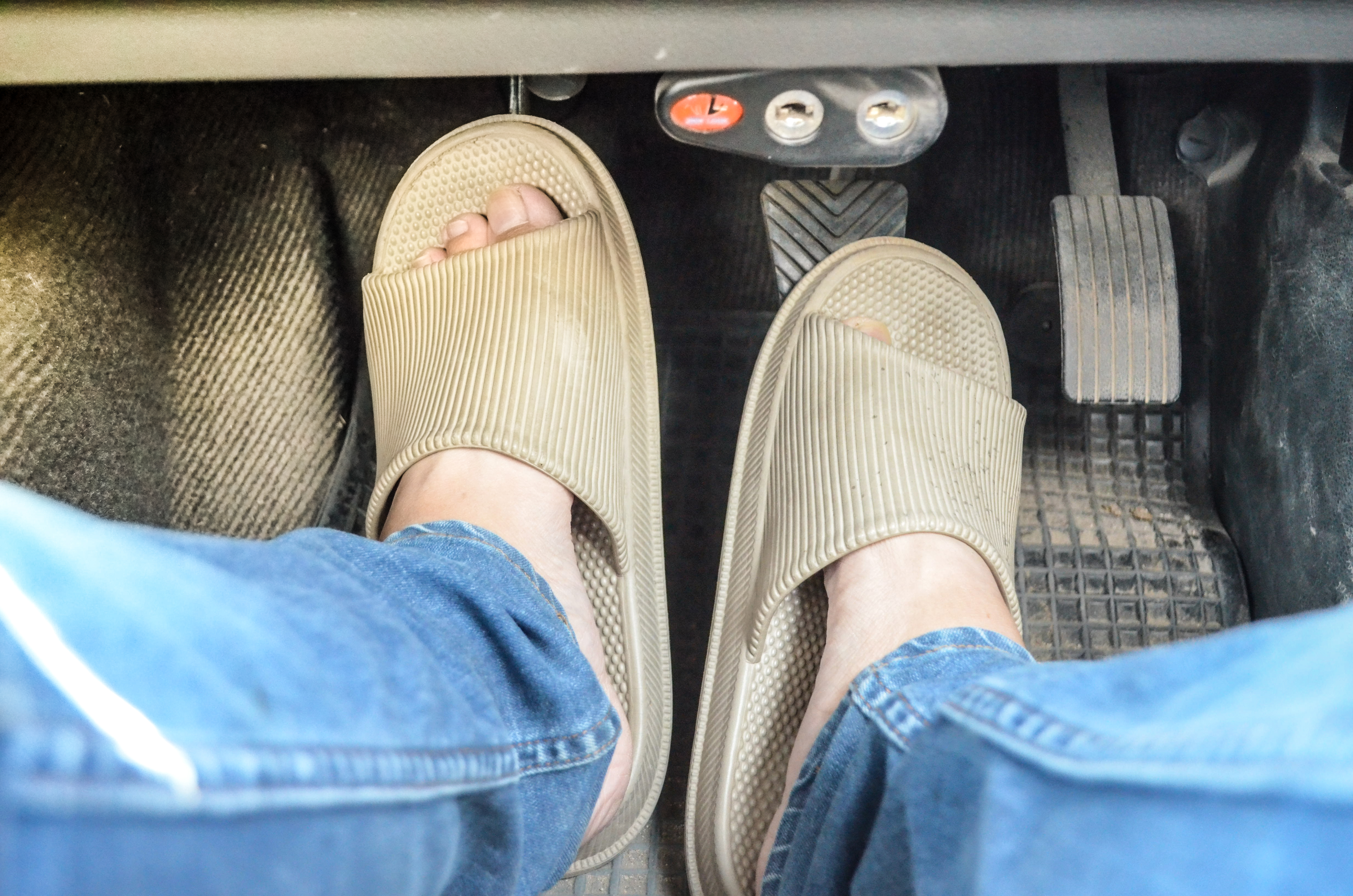 Feet on car pedals