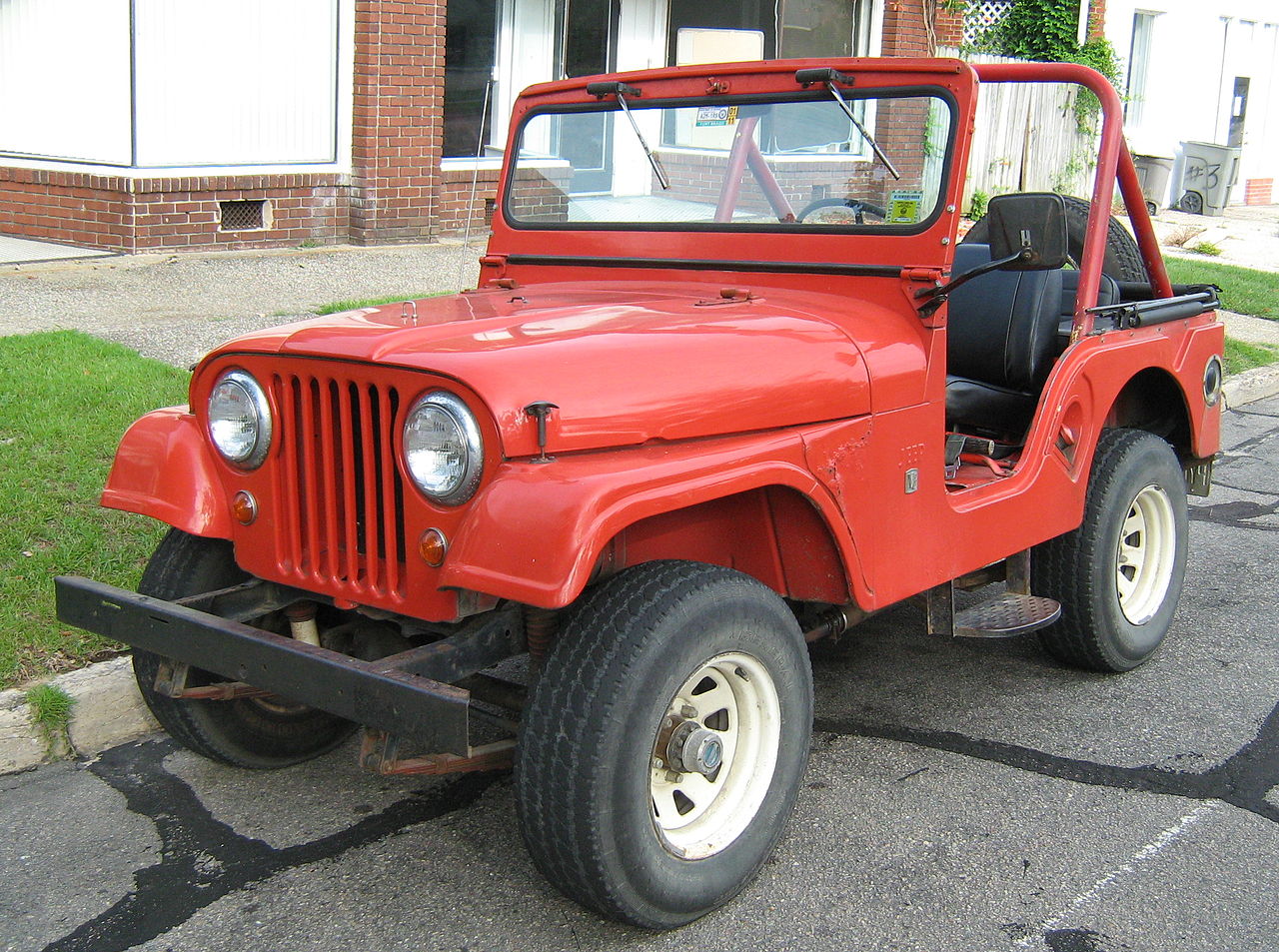 Jeep CJ-5 model with original V6 engine. Red open body.