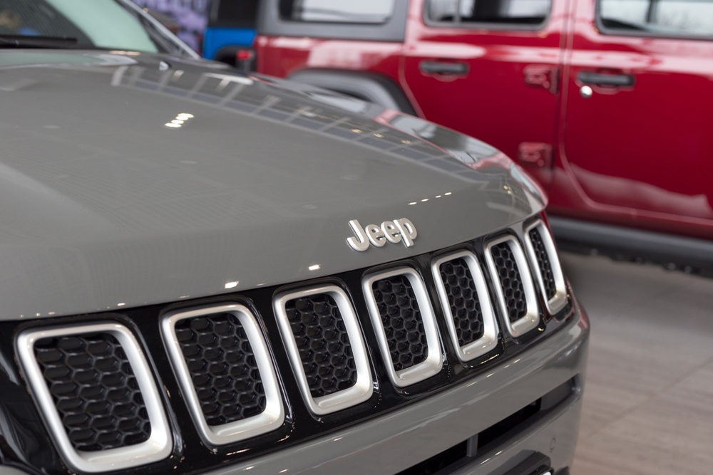 Jeep showroom. Jeep logo on a bumper of new Grand Cherokee.