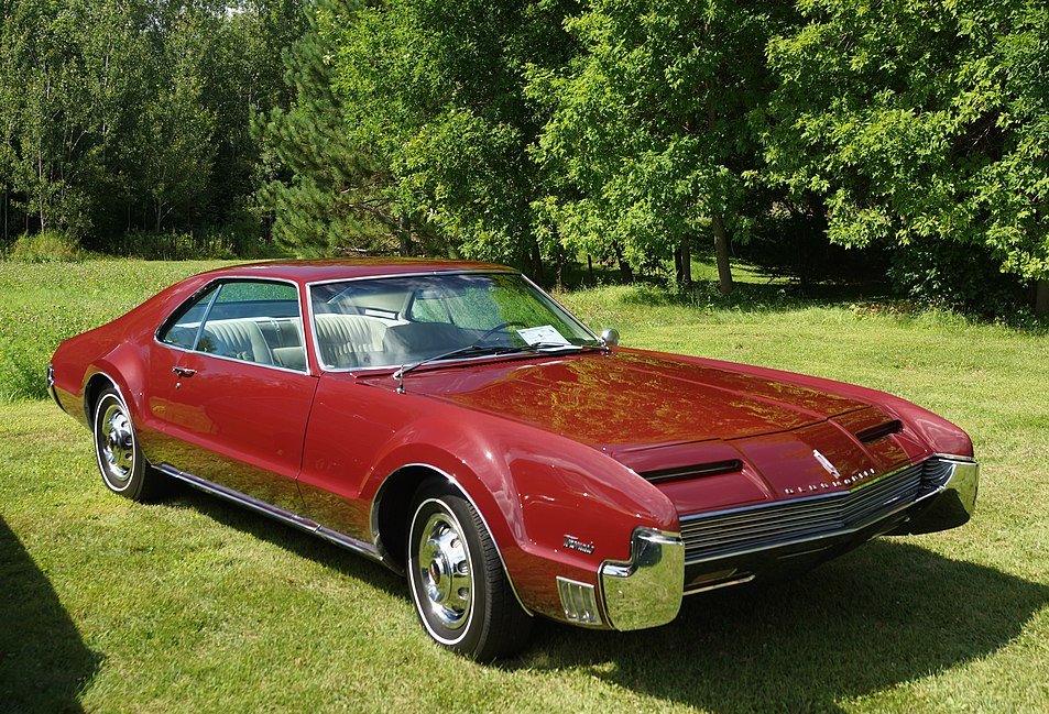Close-up photo of a Red 1966 Oldsmobile Toronado
