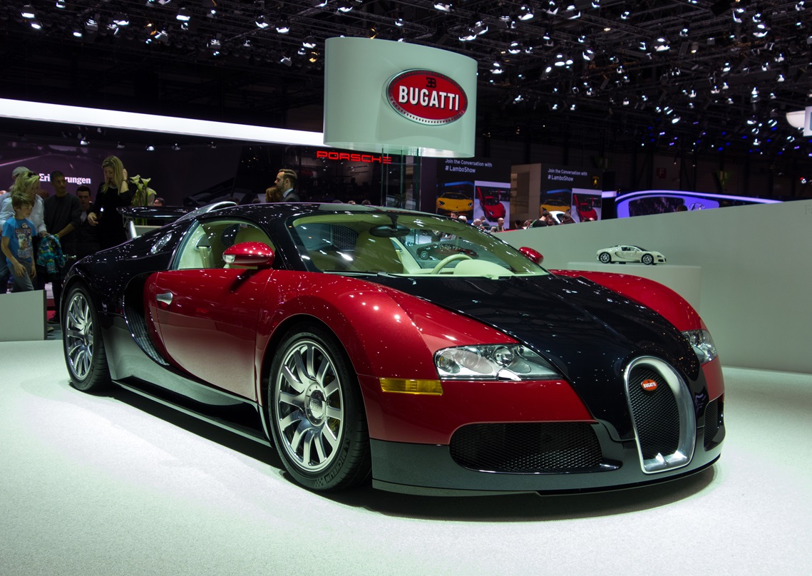 Red Bugatti Veyron at car show.
