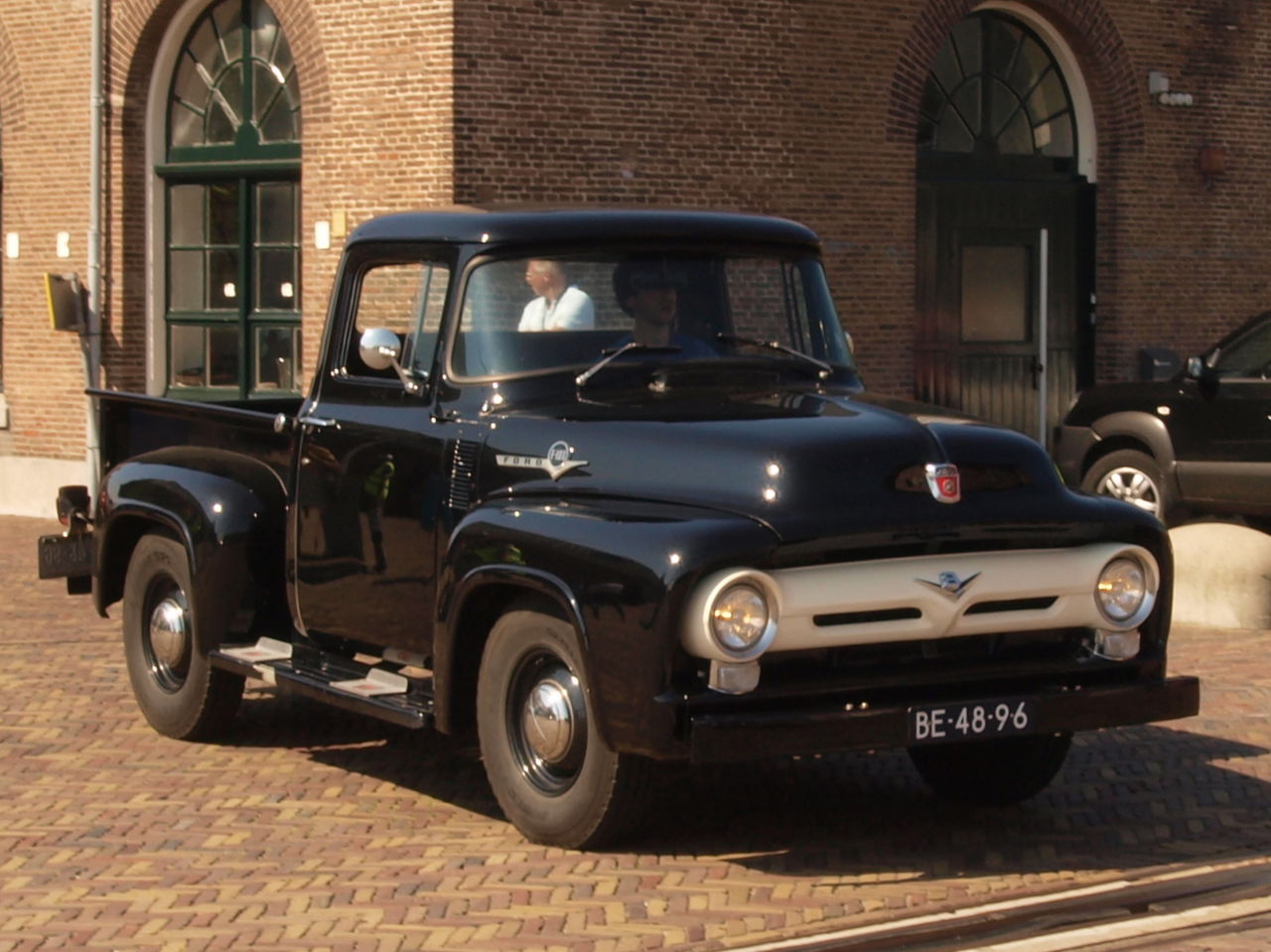 Black Ford F 100 (1956) on the street.