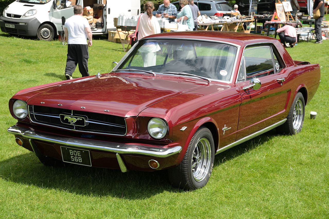 Dark Red Ford Mustang (1964) at car show.