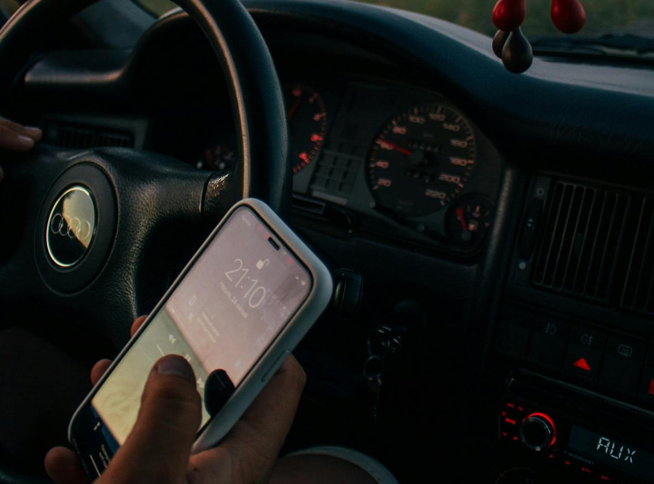 A Person Holding a Smartphone while Driving