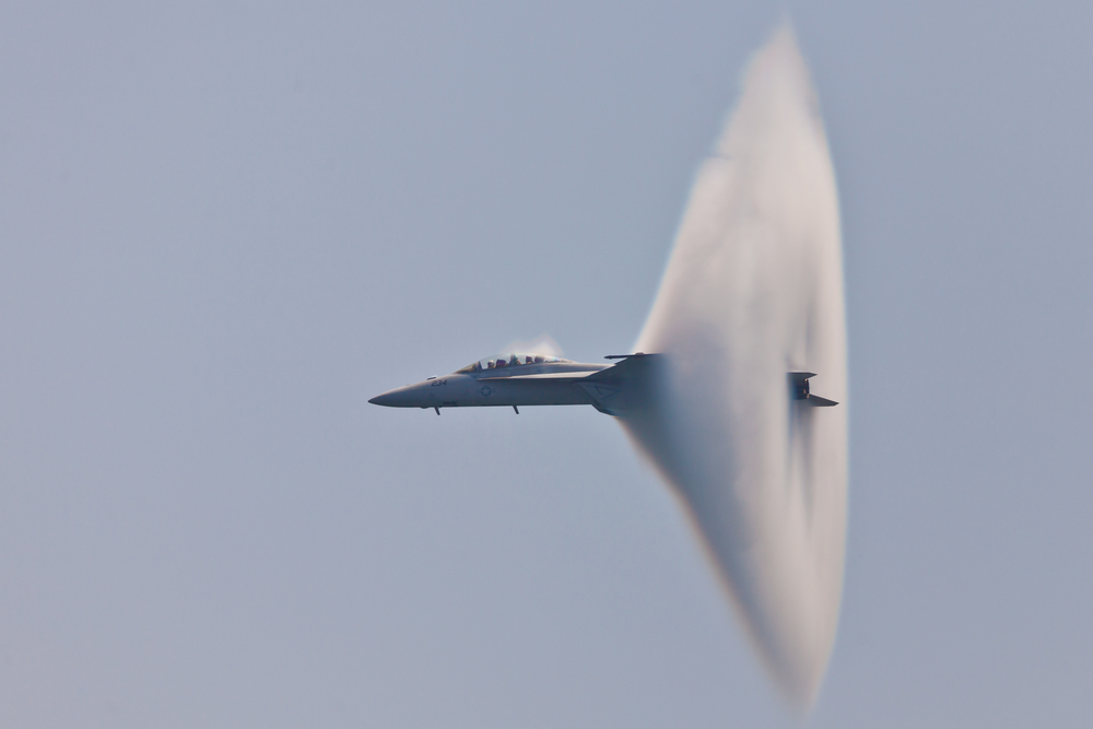 Plane traveling with subsonic speed and visible Vapor Cone that is also called Sonic Boom