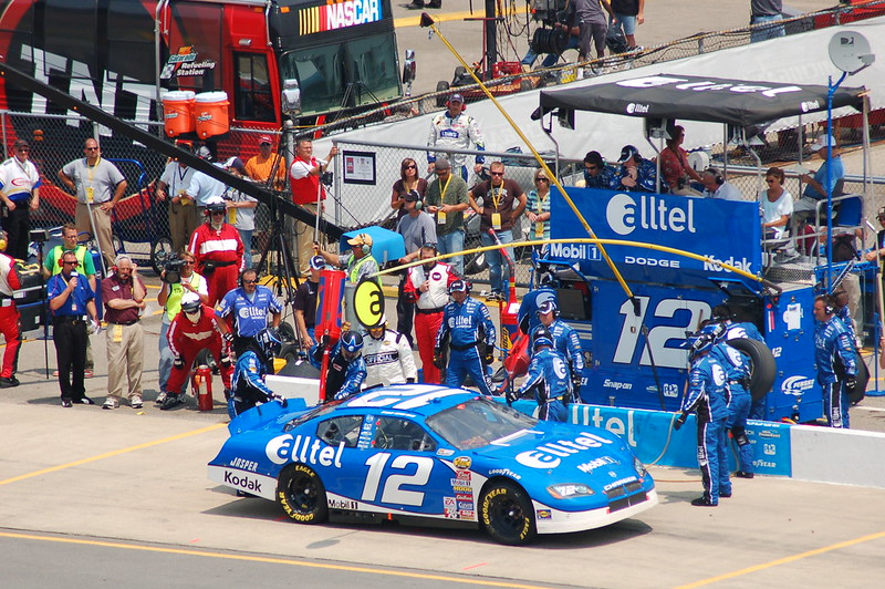 A NASCAR racing car comes in for a pit stop