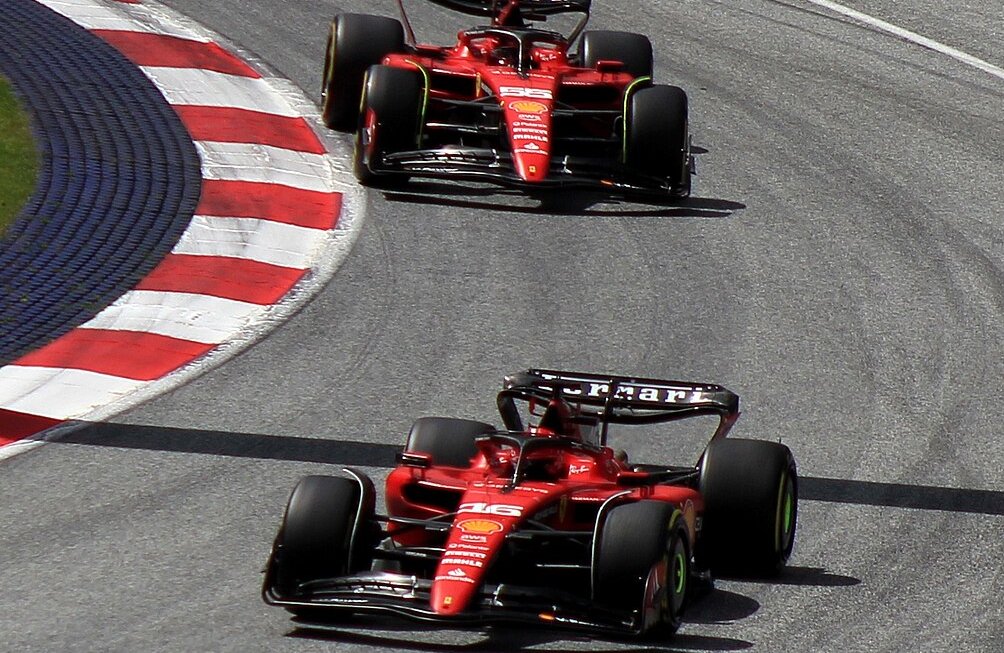 Two red ferrari racing cars