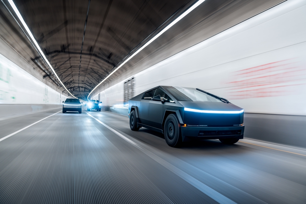 Tesla Cybertrucks driving together in a tunnel