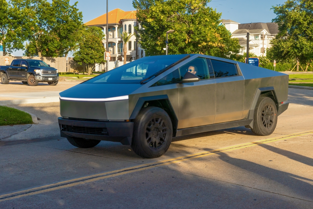 Tesla Cybertruck driving down the street in the downtown districk - 2024