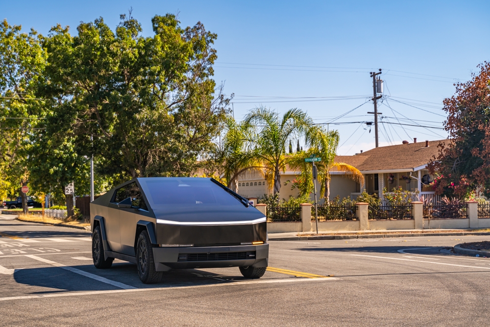 Black Tesla Cybertruck drives through the city - 2024