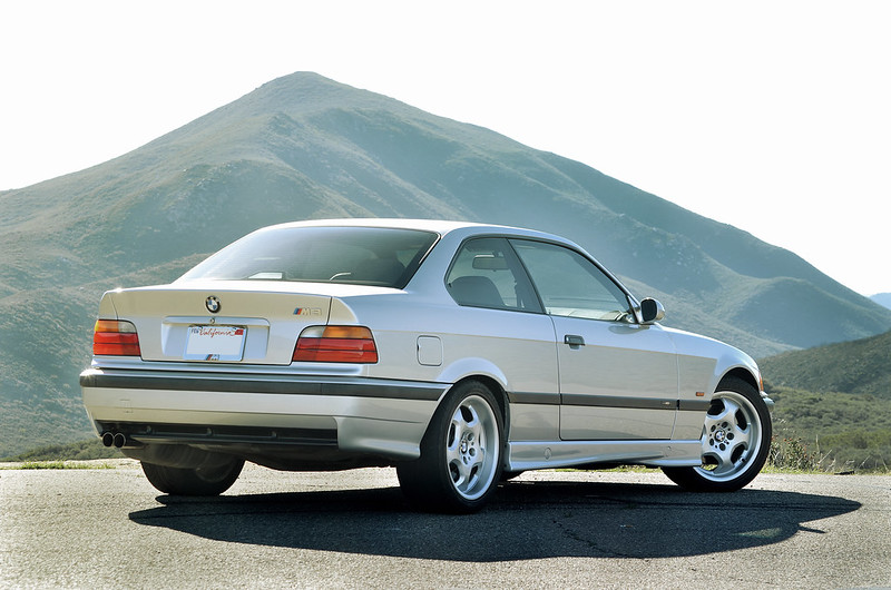A close-up photo of a Silver 1999 BMW M3 Coupe car parked on a street
