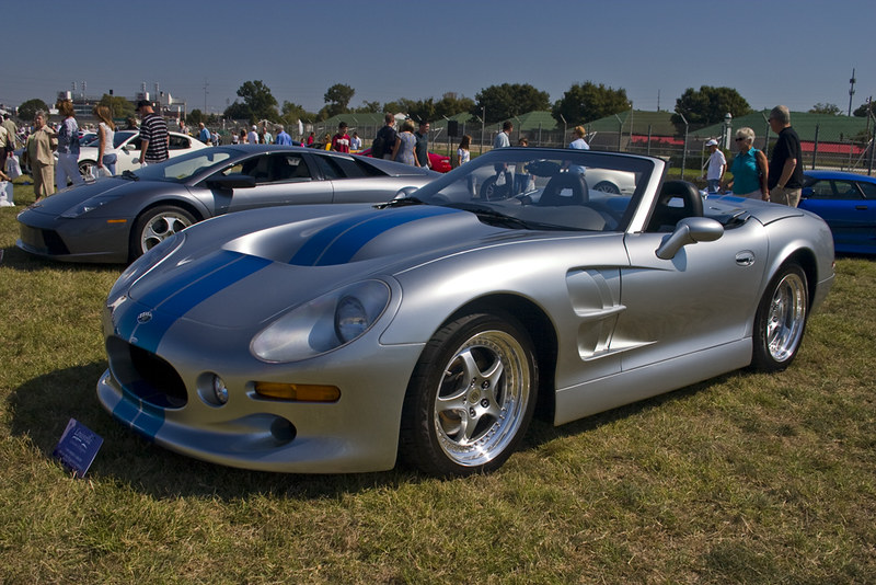 A close-up photo of a Silver 1999 Shelby Series One car on display at an exhibition