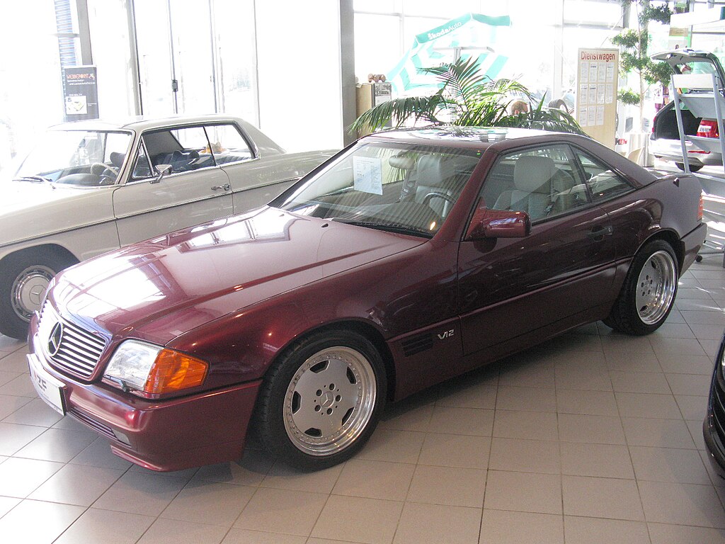 A close-up photo of a Red Mercedes-Benz SL 600 car on display at an exhibition