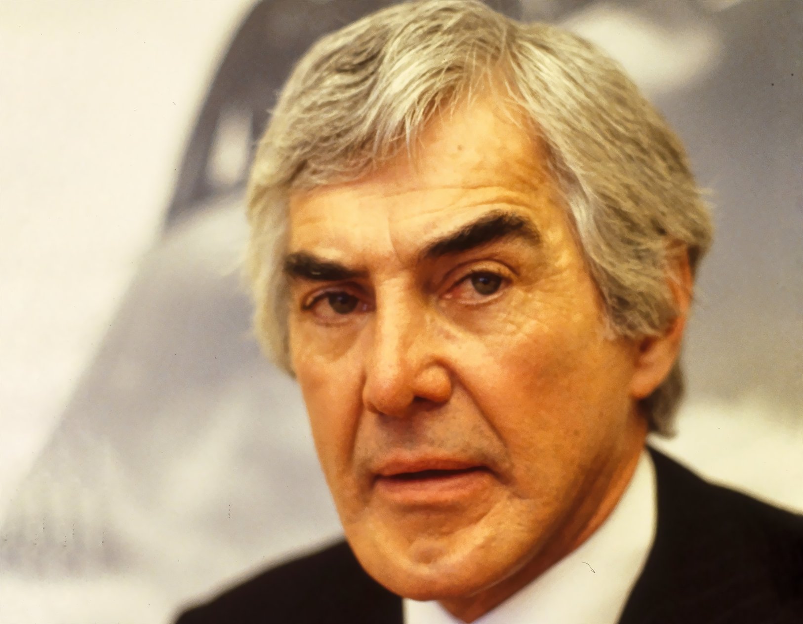 John Delorean wearing a black suit