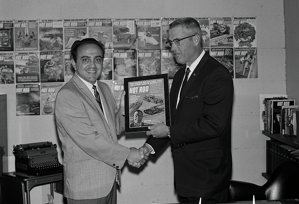 George Barris receives a framed cover of a magazine featuring himself