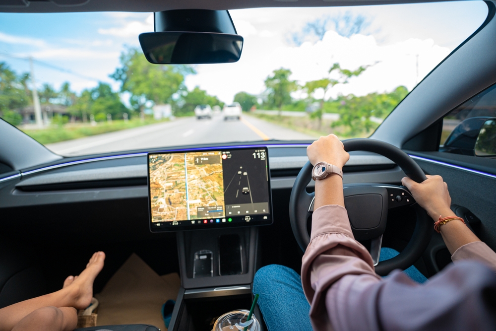 Business woman driving EV car