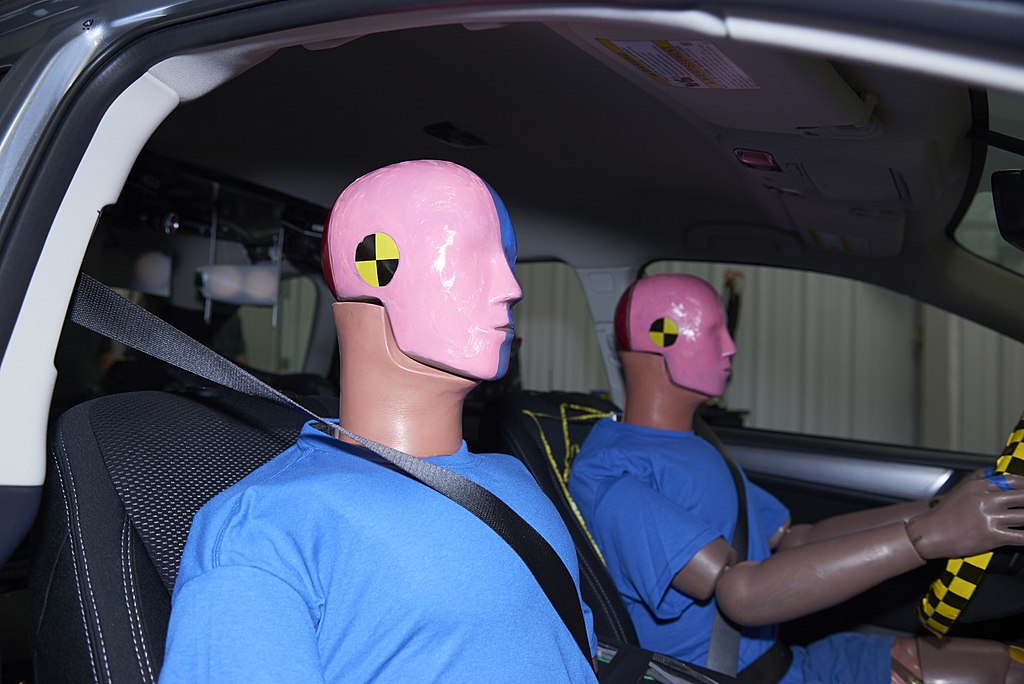 Two male Hybrid III crash test dummies inside a Subaru Outback.