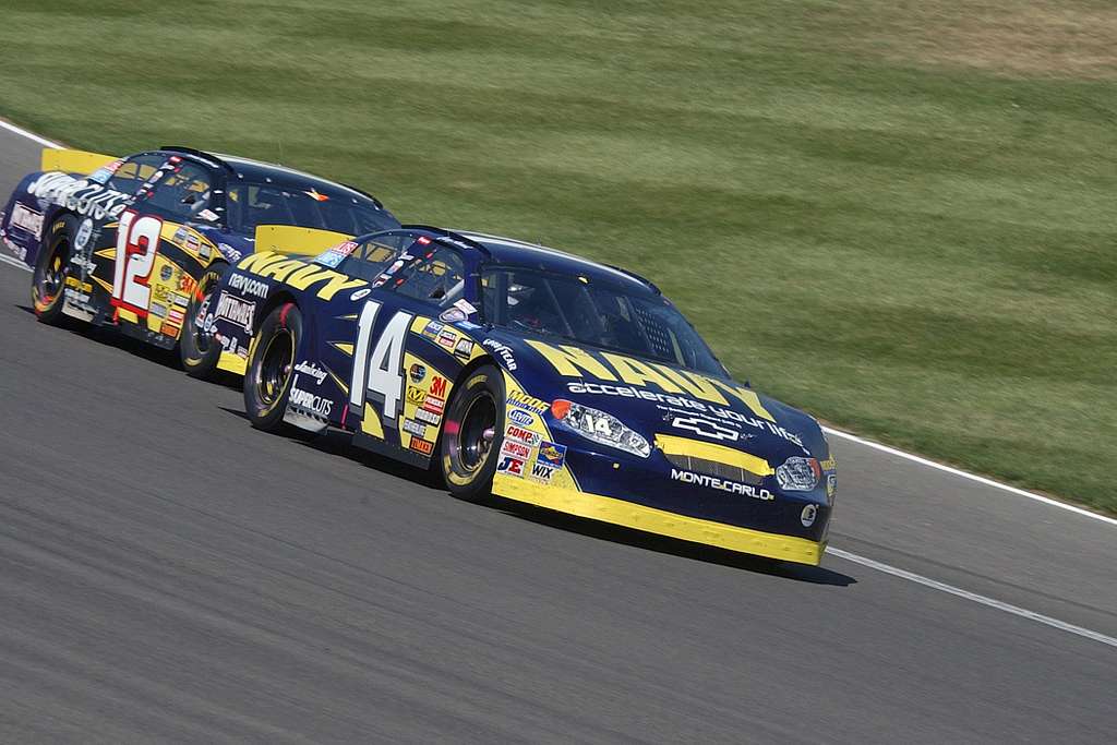 The Navy No. 14 Chevy Monte Carlo NASCAR roars around turn three during the Stater Bros. 300 race