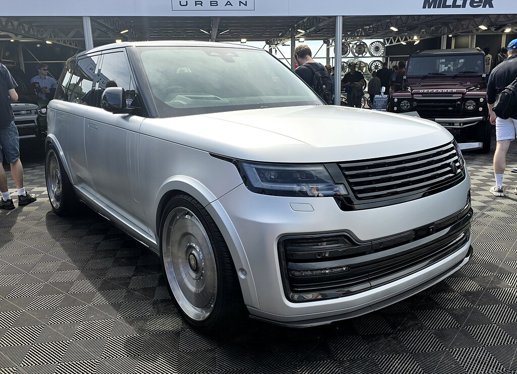 A close-up photo of a Silver 2024 Range Rover Urban car on display at an exhibition