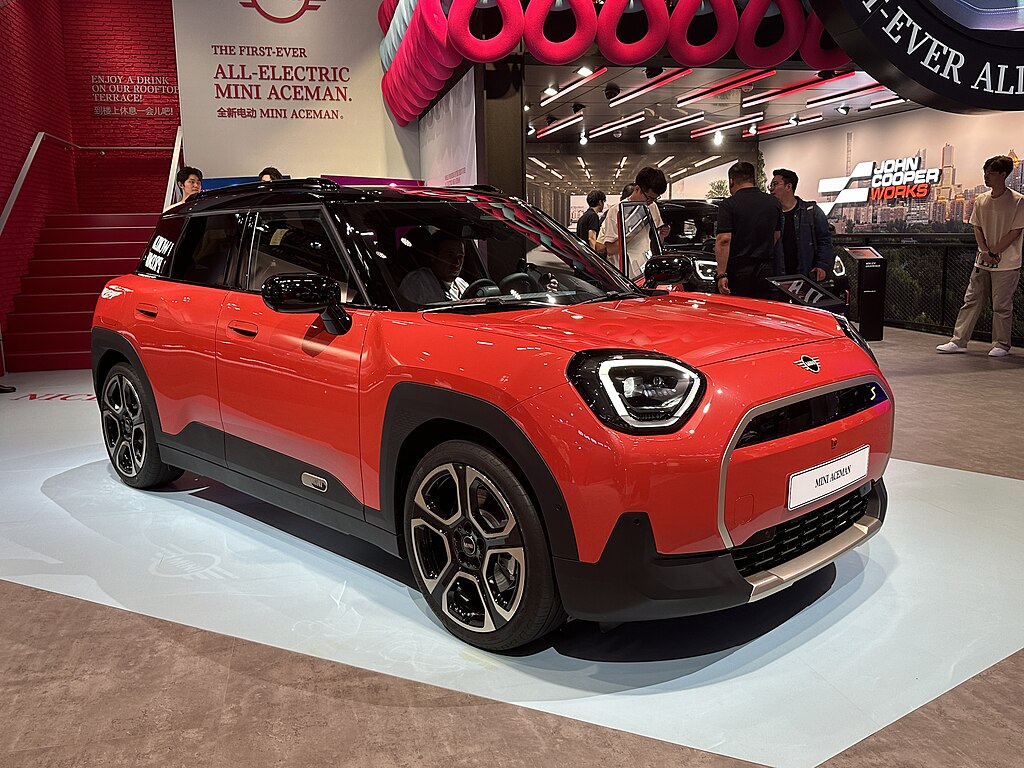 A close-up photo of a Red Mini Aceman car on display at an exhibition