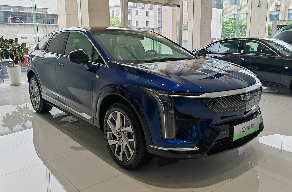 A close-up photo of a Blue Cadillac Optiq car on display at an exhibition