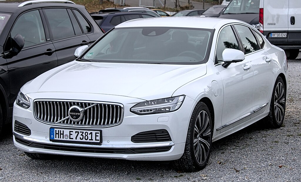A close-up photo of a White Volvo S90 car parked in a parking lot