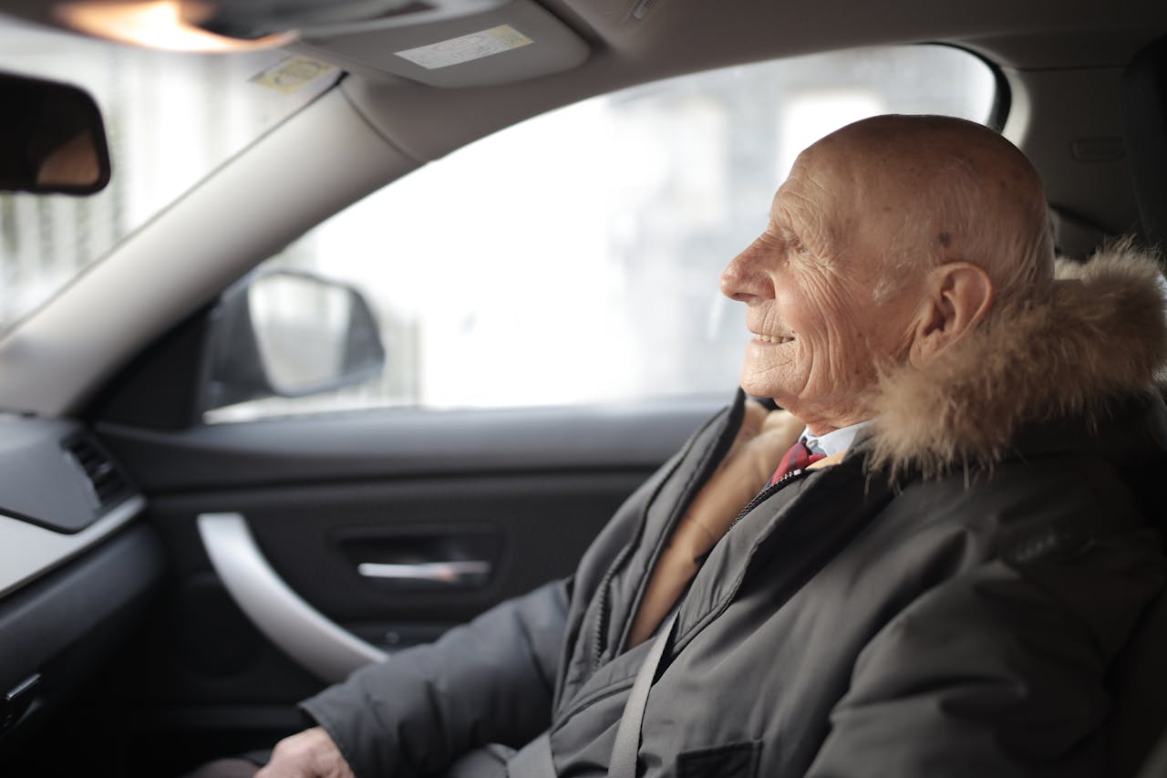 Smiling senior man in modern car.