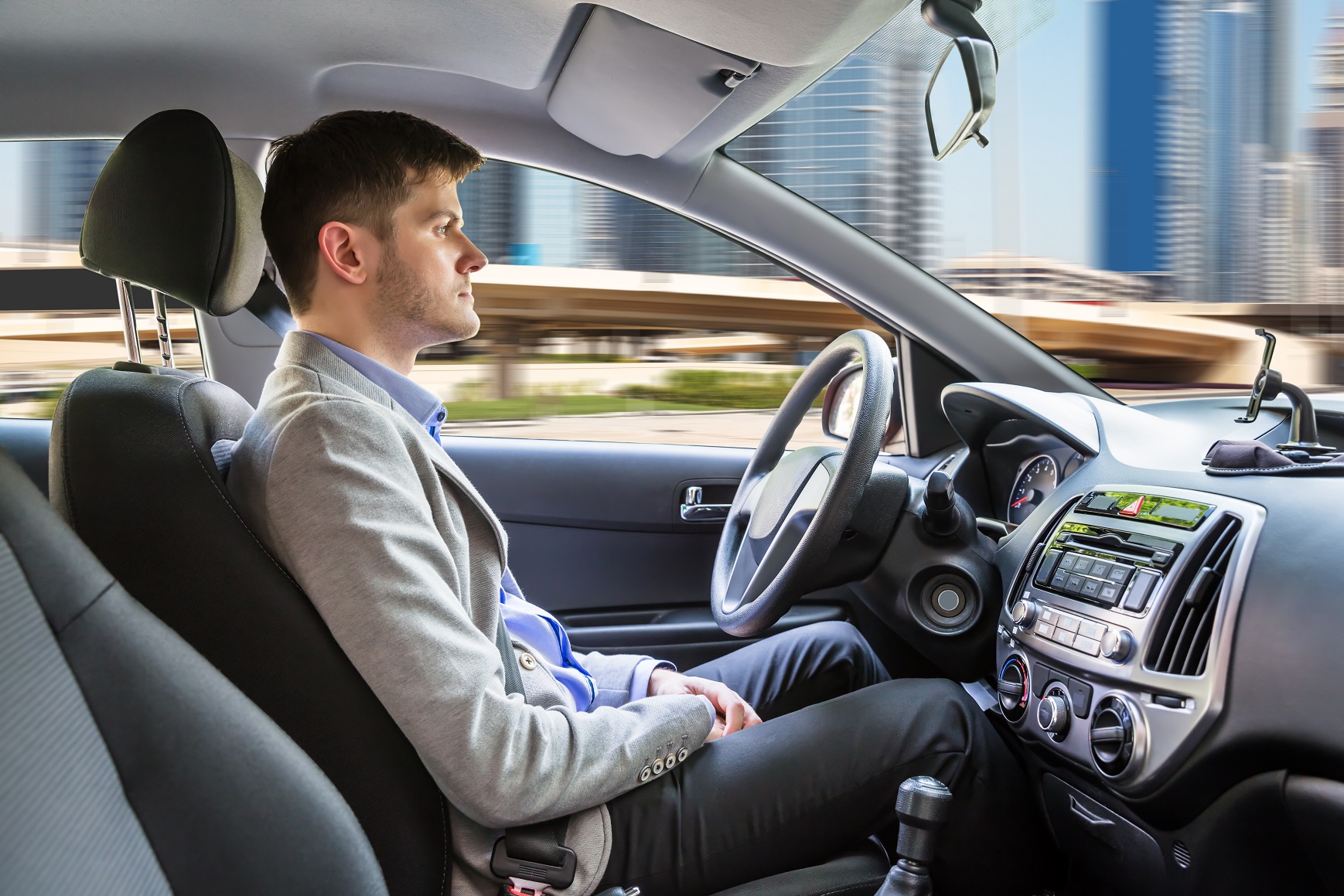 Side View Of A Young Man Sitting Inside Autonomous Car