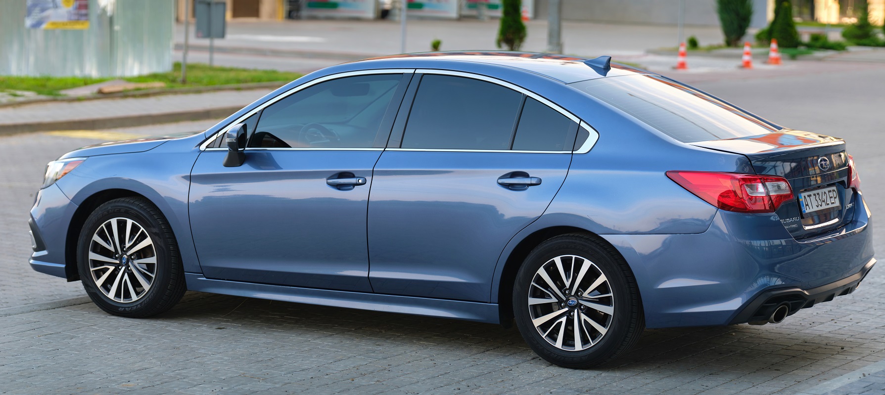 Panoramic view of new shiny Subaru Legacy car parked on city street side. Kyiv, Ukraine
