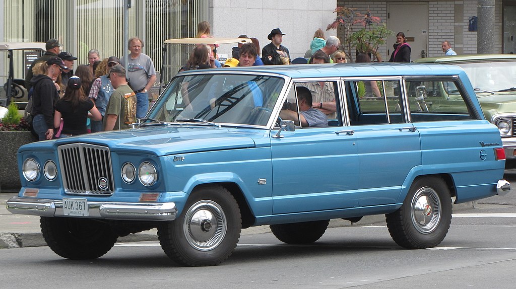 Close Up Photo of Blue 1963 Jeep Wagoneer on the street