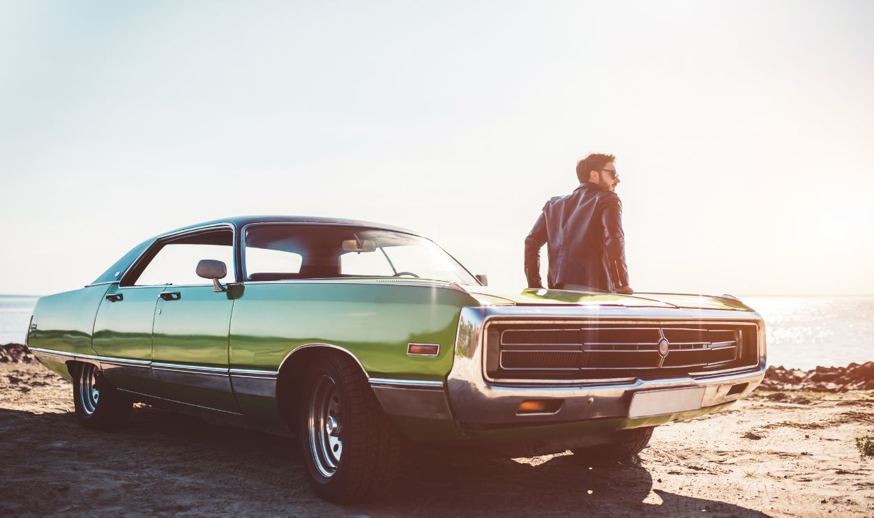 Man with vintage car