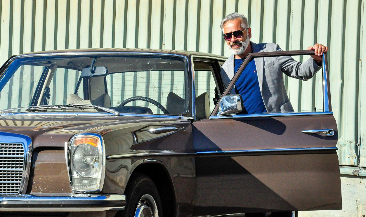 Middle-aged man with his Mercedes classic car
