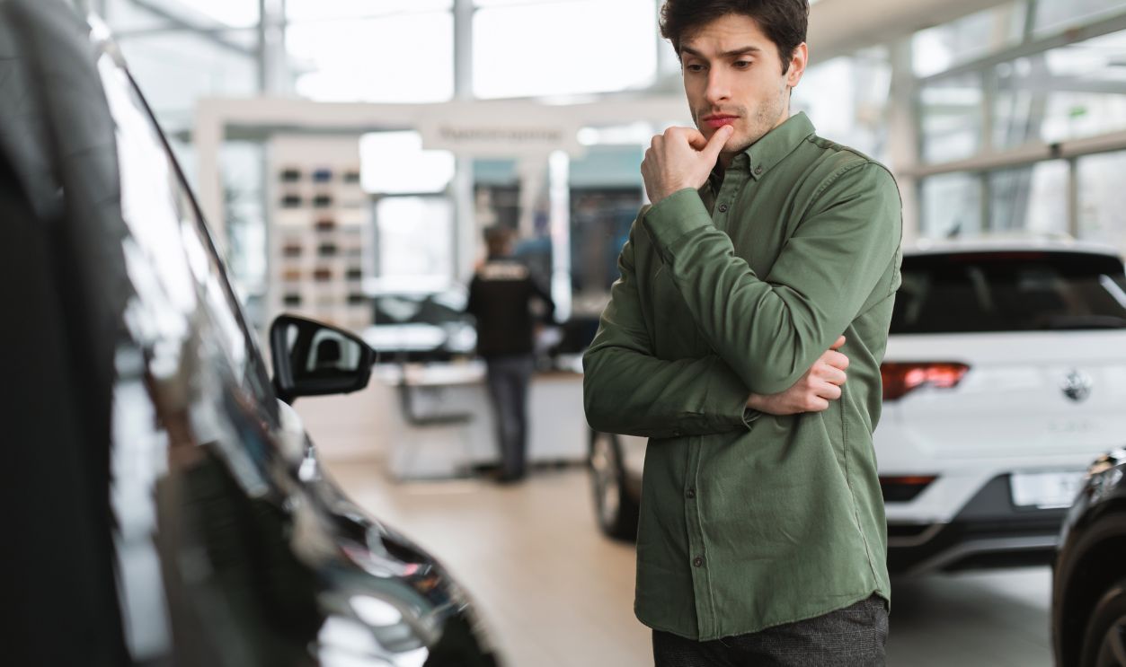 Man seriously wathcing the car and thinking