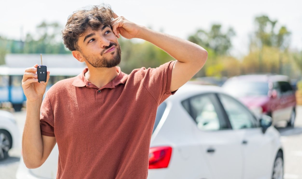 Man with car key confused
