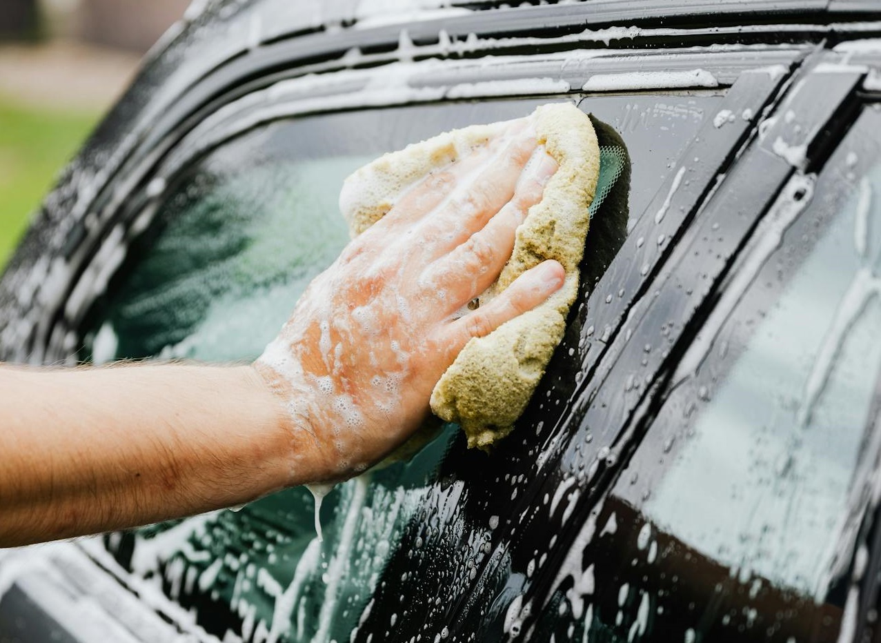 Person Washing a Car with Sponge