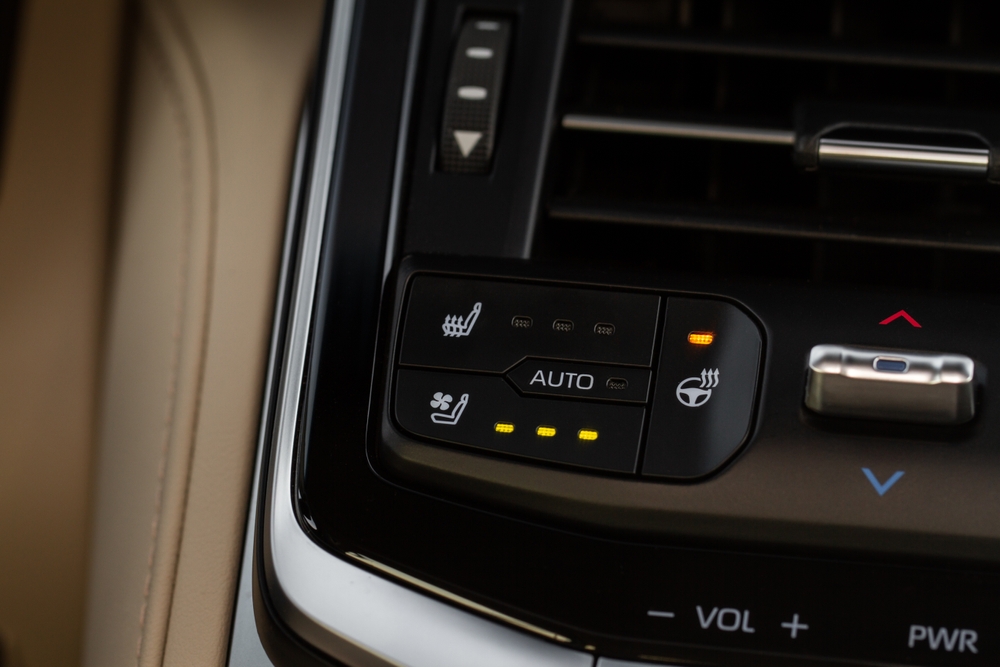 Close up of car steering wheel heating control.