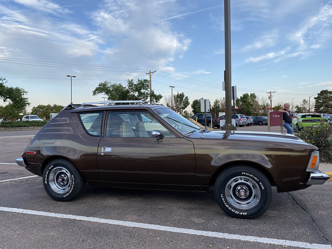 Right side view of a 1973 AMC Gremlin X package 258 auto finished in Cordoba brown and gold stripes