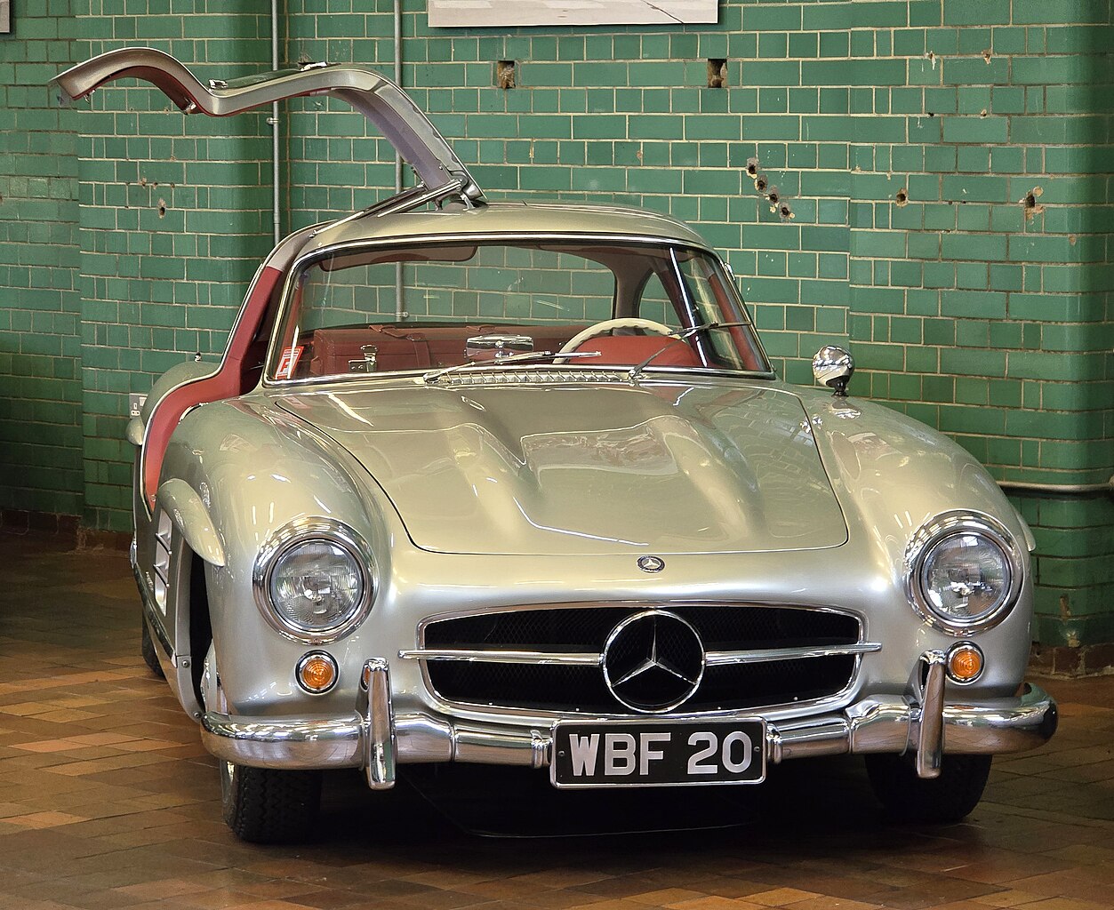 A close-up photo of a 1955 Mercedes-Benz 300SL car on display at an exhibition