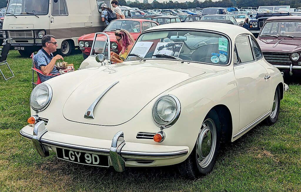 A close-up photo of a White 1966 Porsche 356 C car on display at an exhibition