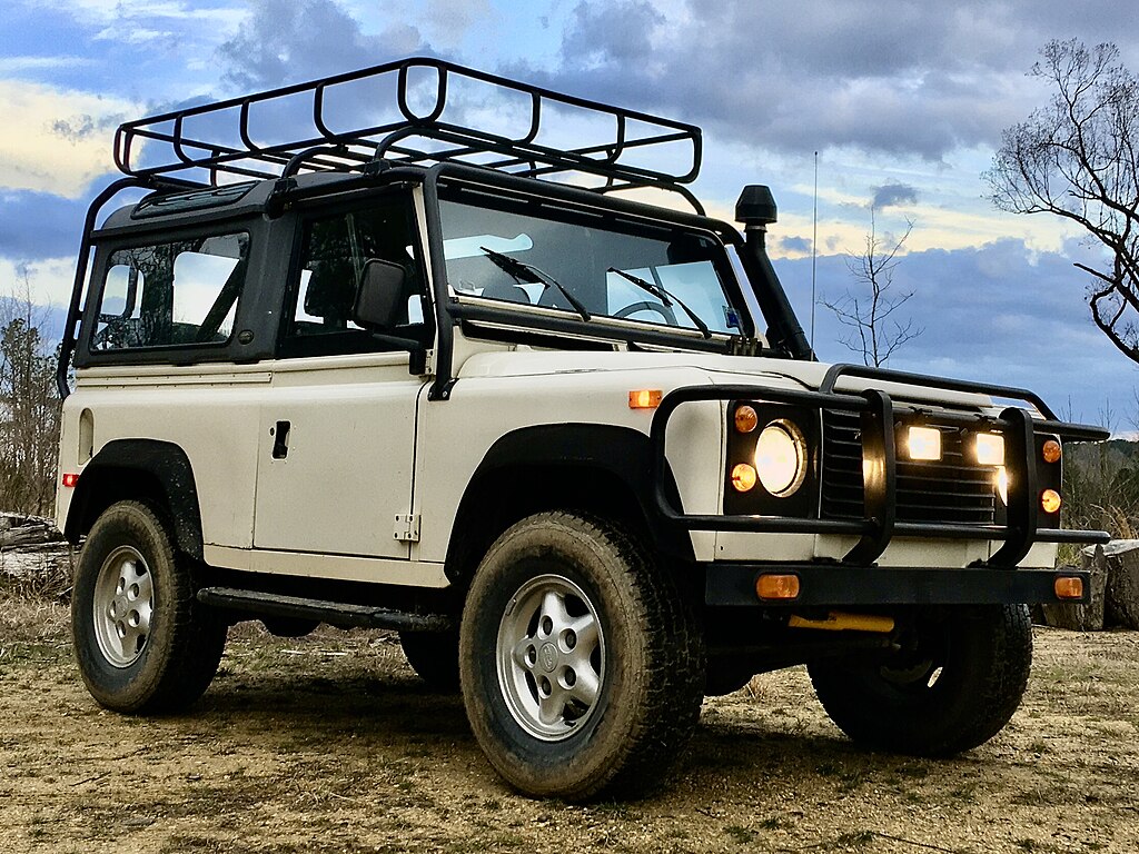 A close-up photo of a 1994 Land Rover Defender 90 car parked outdoor