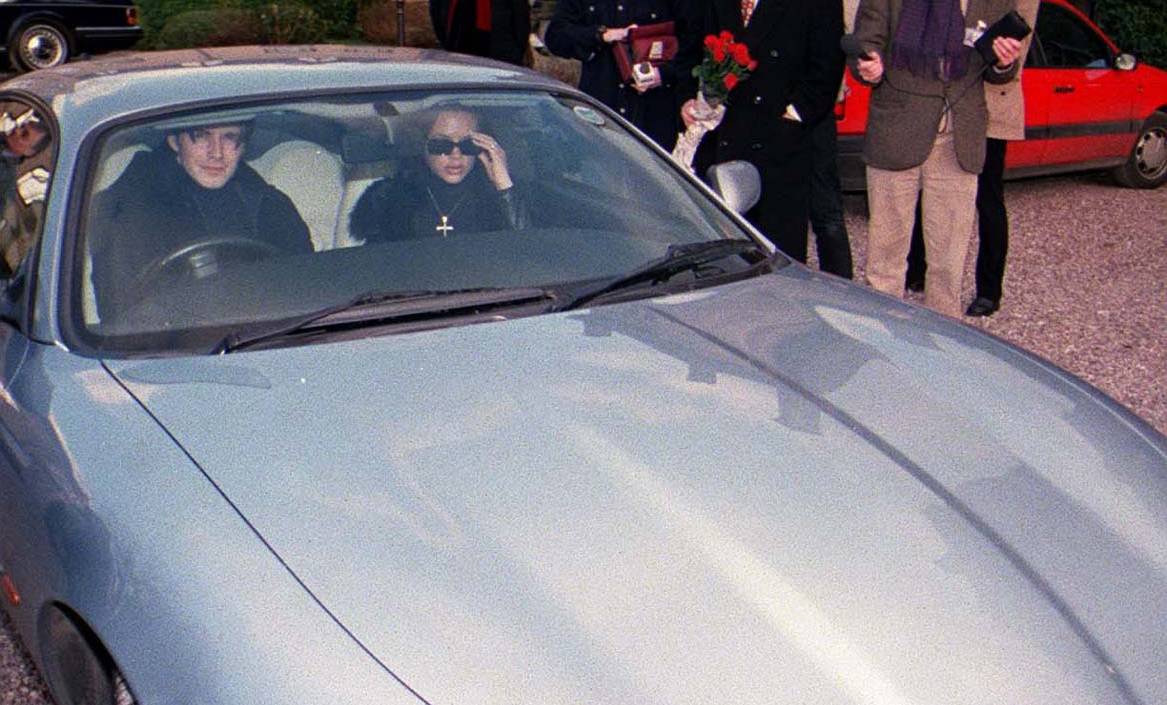 Victoria Adams (Posh Spice) and David Beckham the Manchester United footballer in  pale blue metallic XK8 Jaguar car