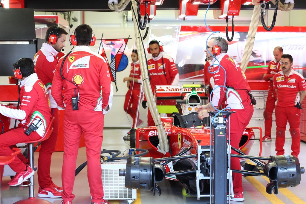 A group of men working on a Ferrari F1 race car