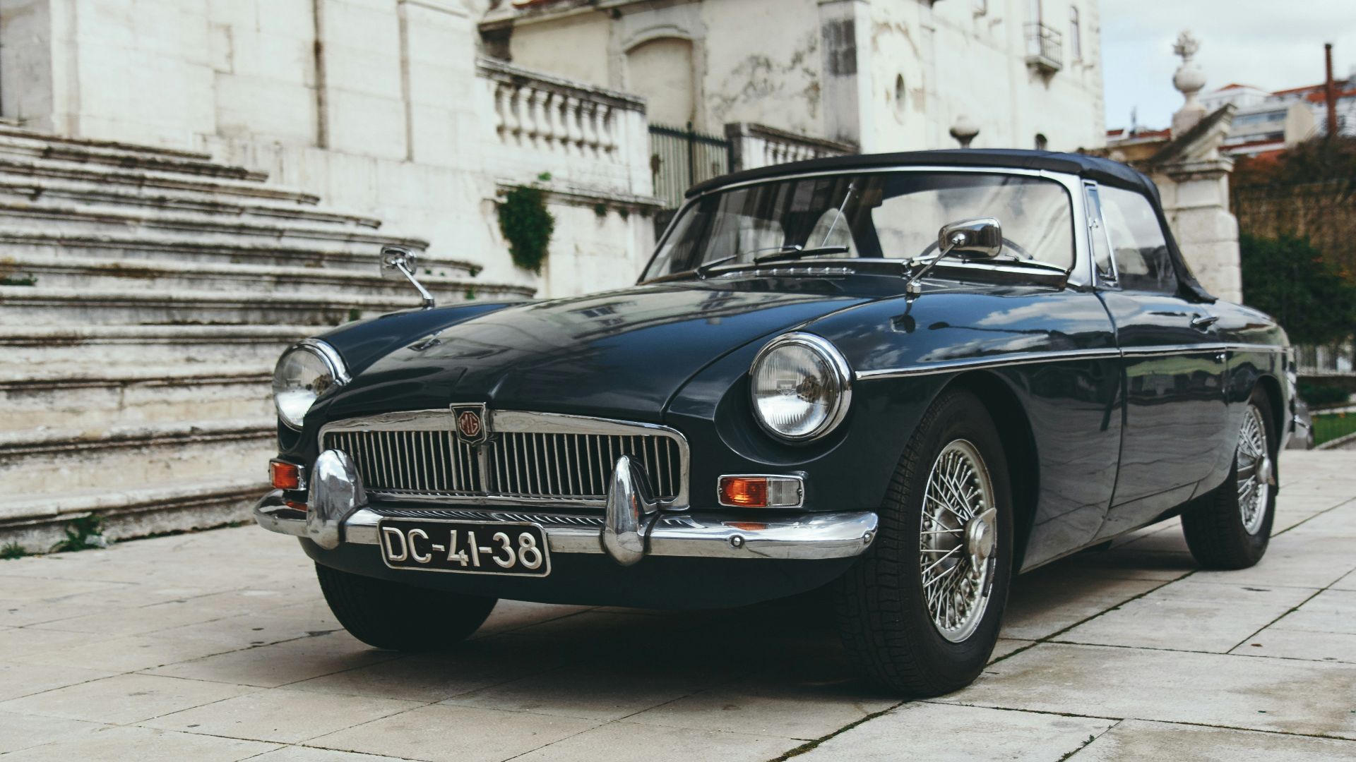 blue coupe near gray concrete staircase