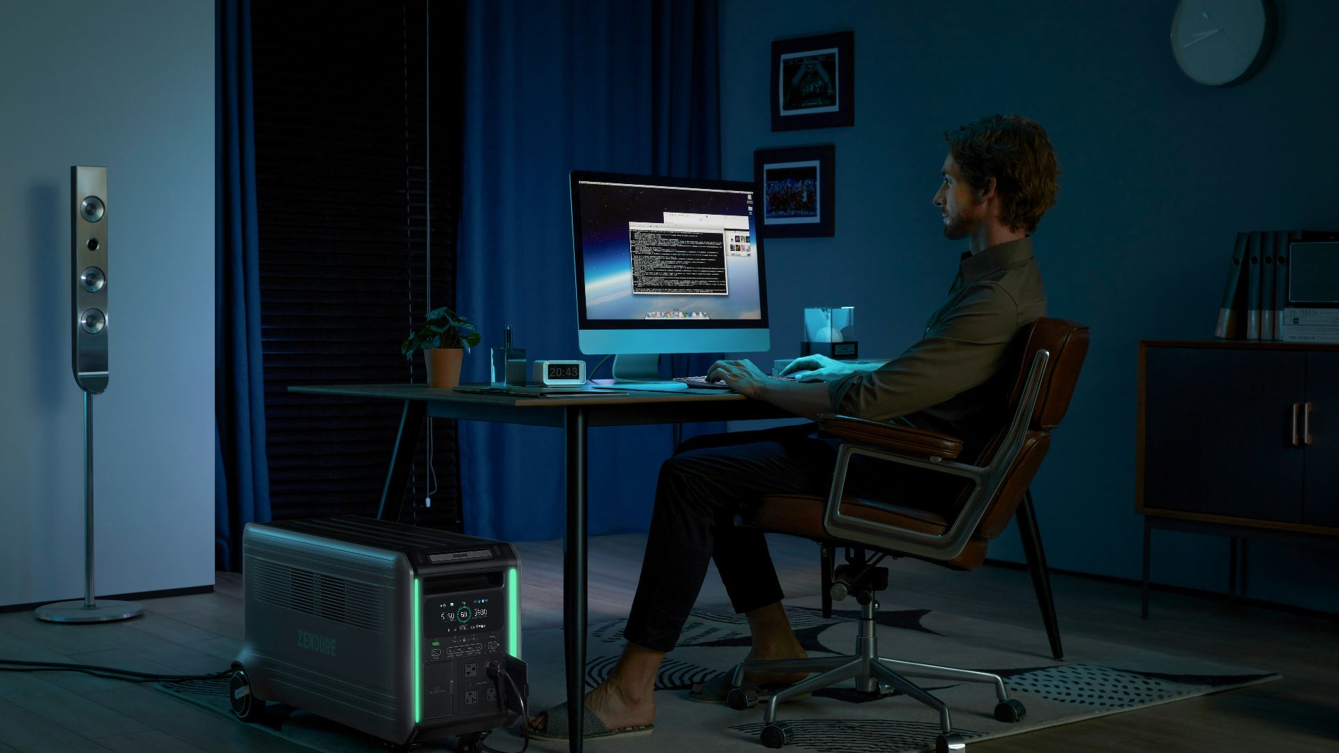 a man sitting at a desk in front of a computer
