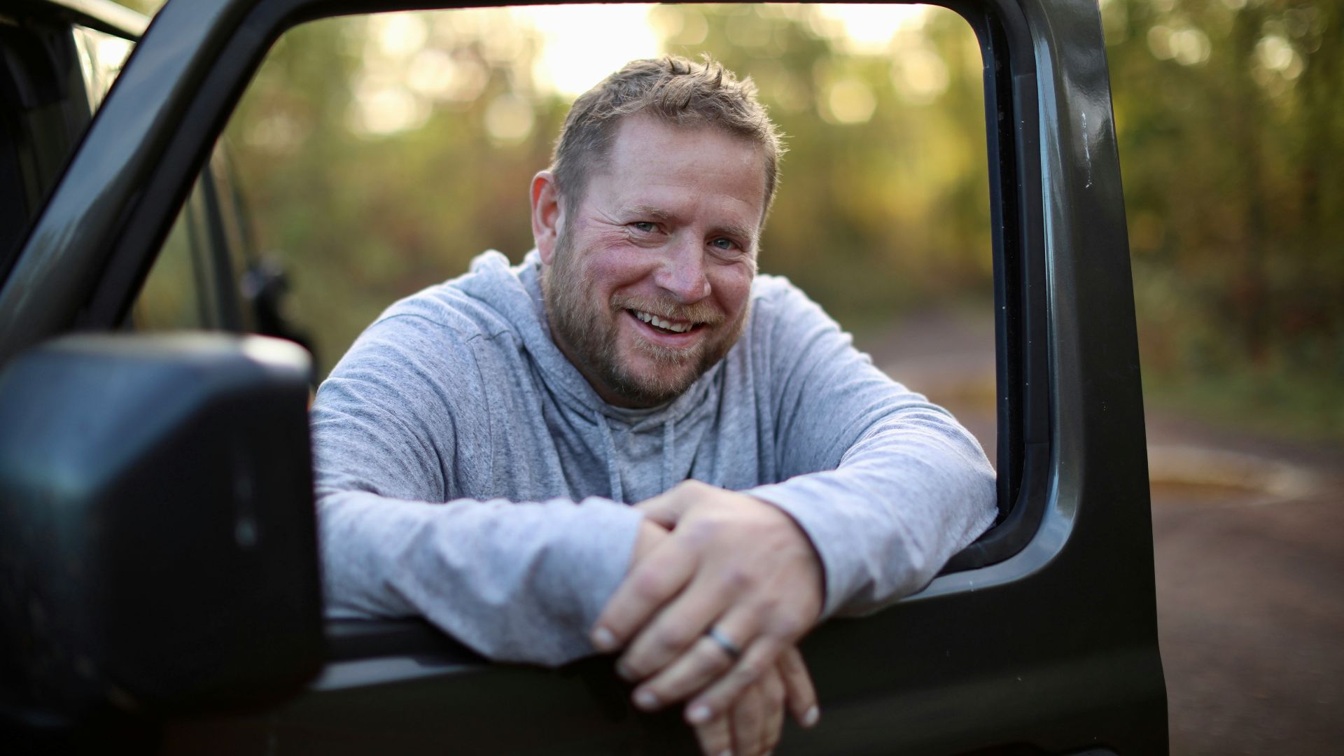 a man sitting in the back of a truck