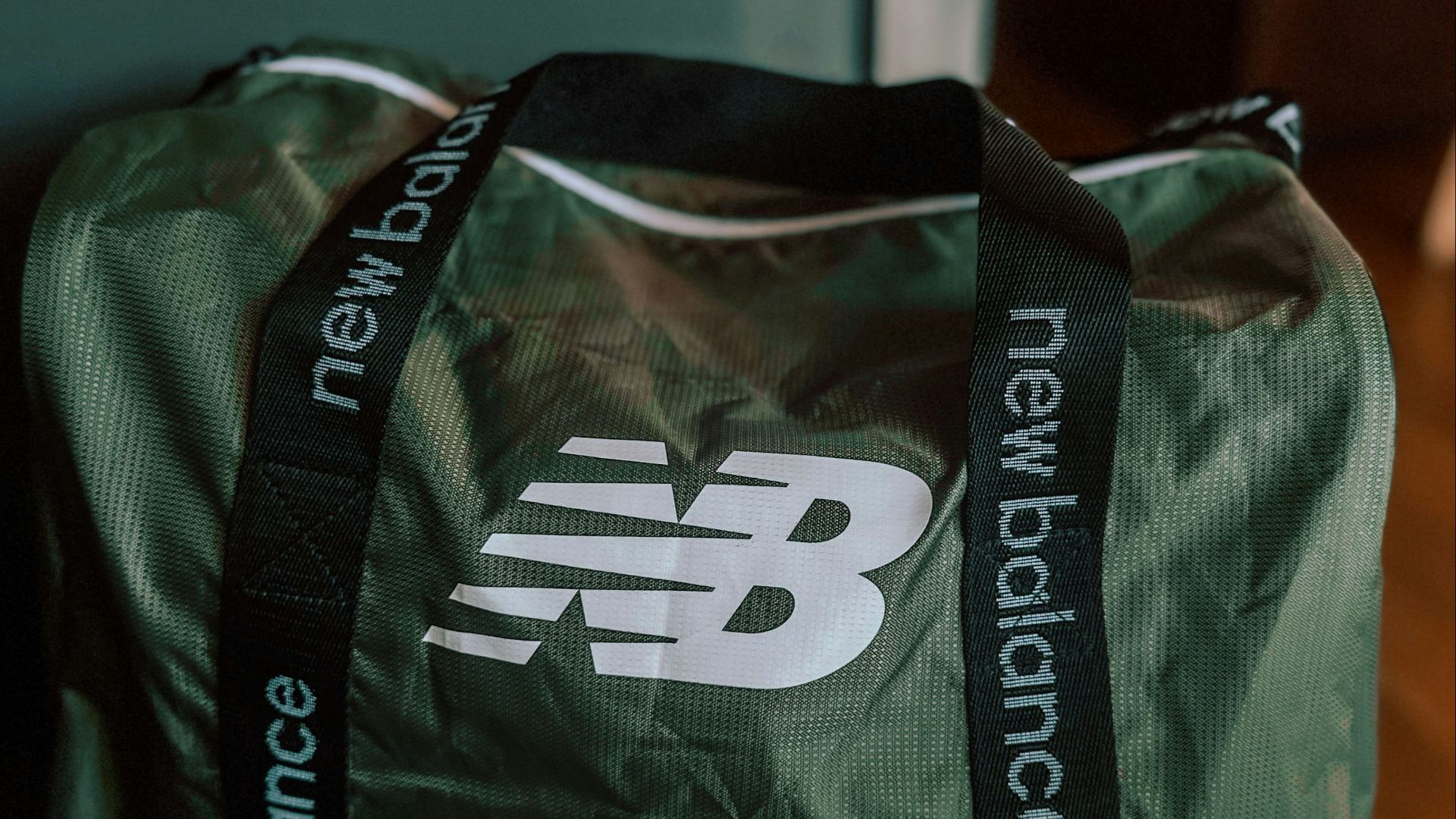 a green bag sitting on top of a wooden table