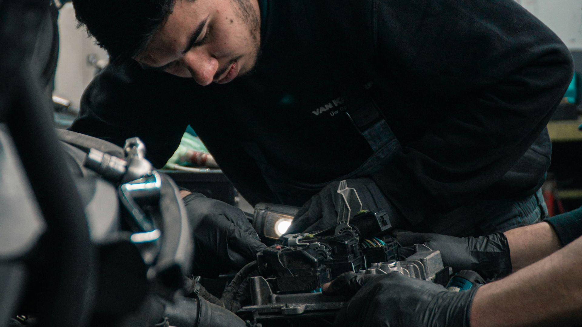 man in black jacket and blue denim jeans riding motorcycle