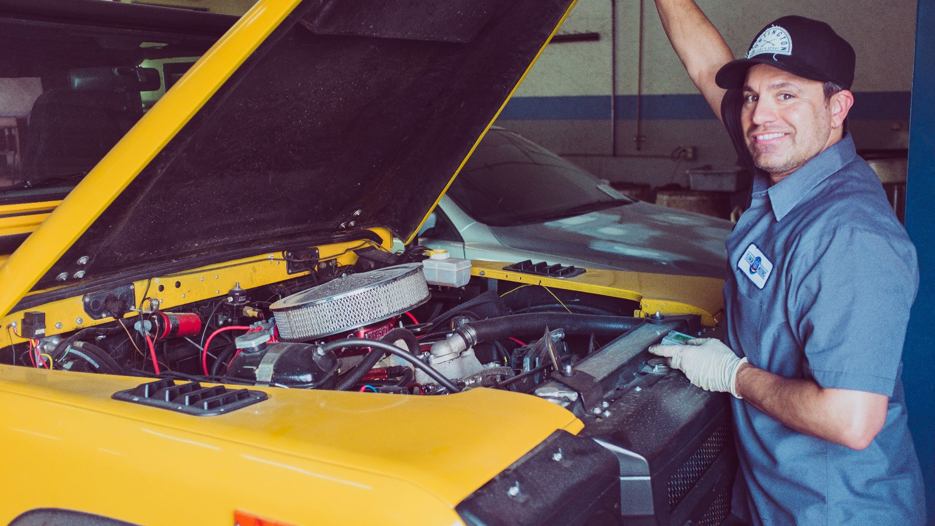 man holding open-wide car trunk