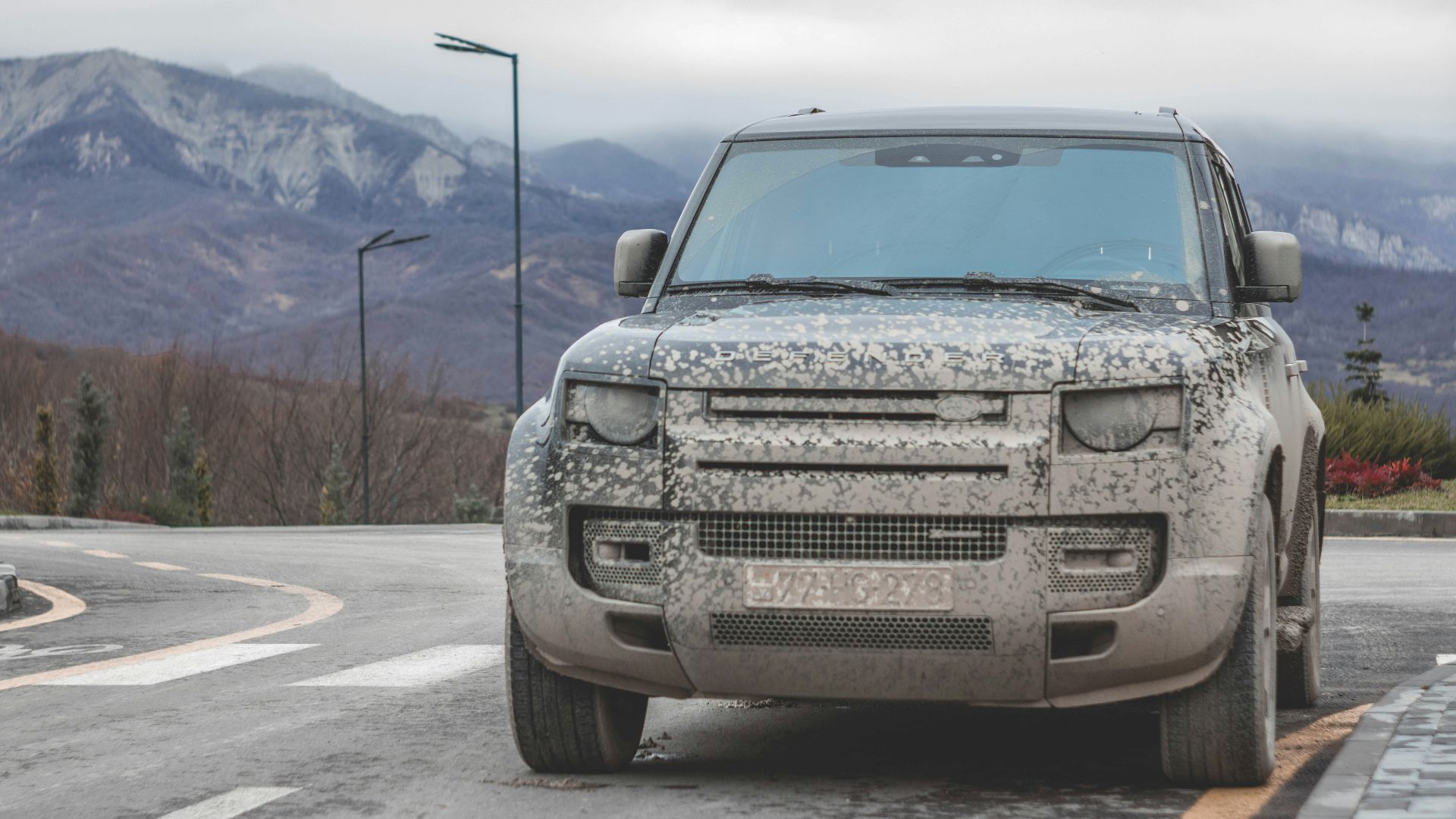 a silver truck parked on the side of a road